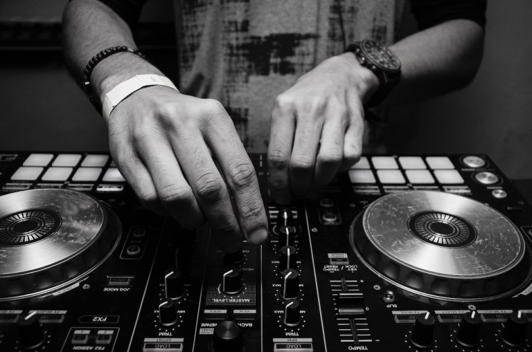 Hands of DJ mixing music